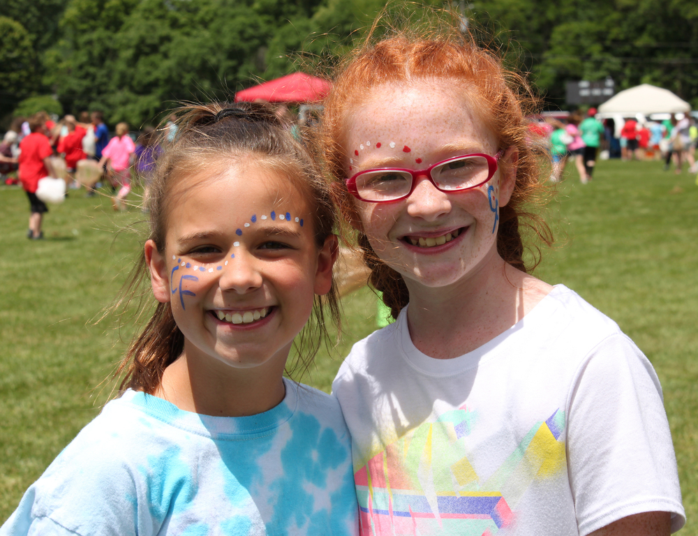 Little girls with face paint enjoy Country Fair 