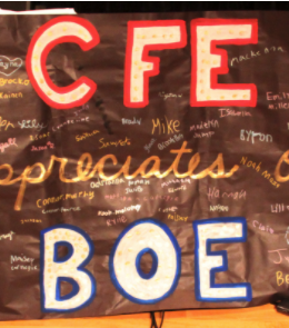 black banner with student signatures that reads "CFE appreciates our BOE" in white letters