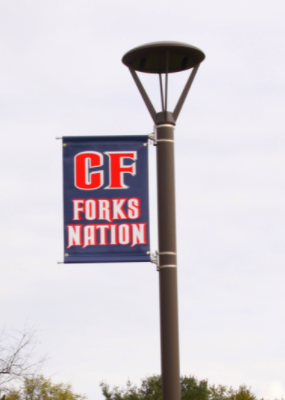 brown light pole with new CF banner reading "CF Forks nation" attached on the left side